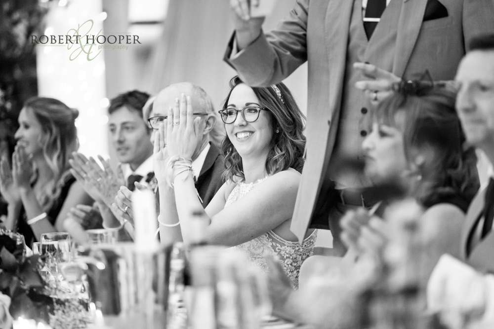 denbies-wedding-breakfast-dorking bride clapping during speeches at Denbies Wine Estate