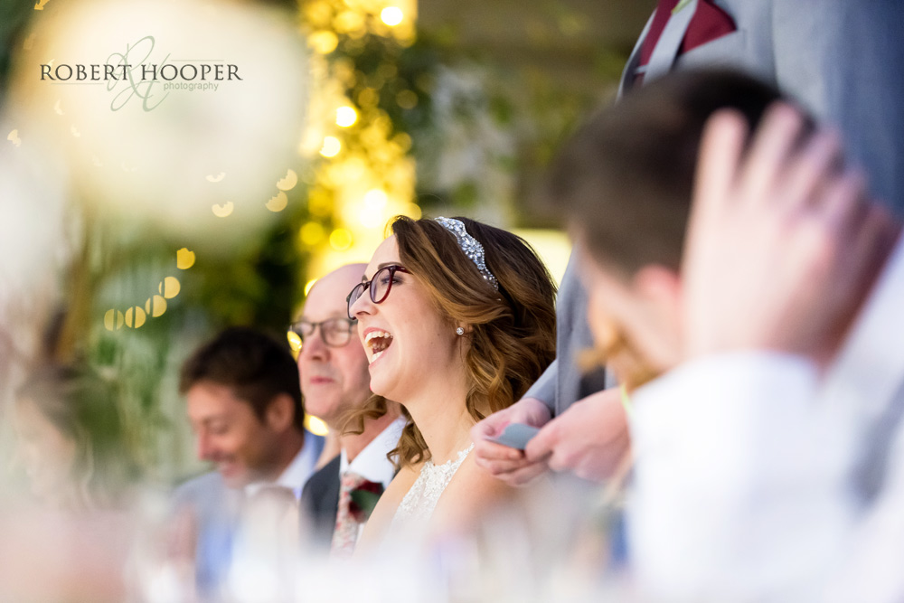 wedding-photographers-surrey bride laughing at groom's speech Denbies