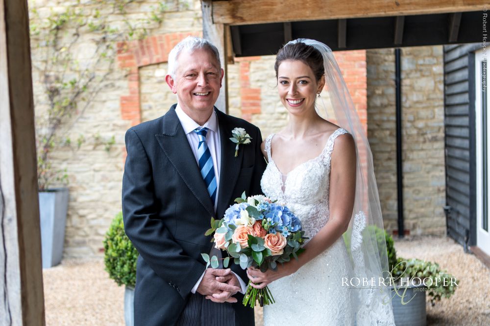 High quality wedding photography Surrey Bride and her dad leaving Millbridge Court for church on wedding day