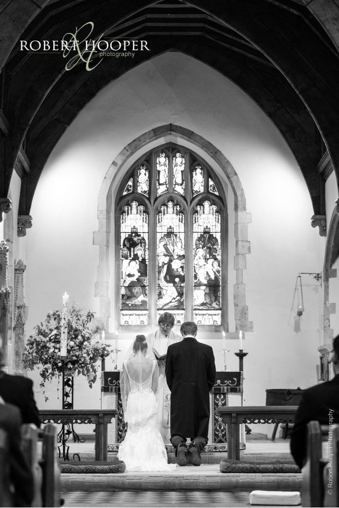 Surrey wedding photography Bride and groom at alter during wedding in church