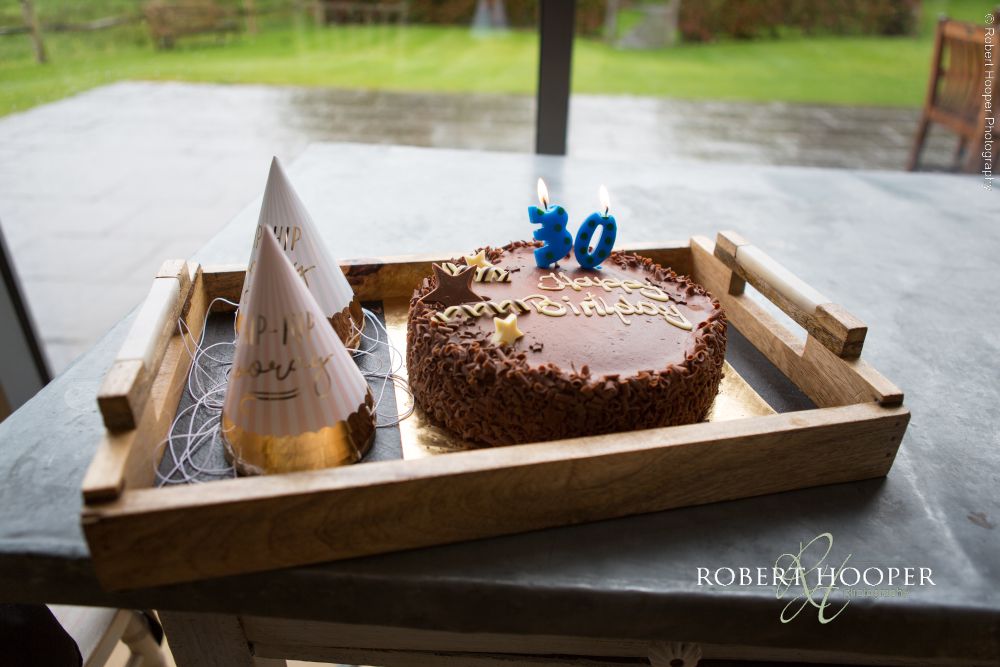 Birthday on wedding day Millbridge Court Surrey Chocolate birthday cake on table for groom on wedding day at Millbridge Court