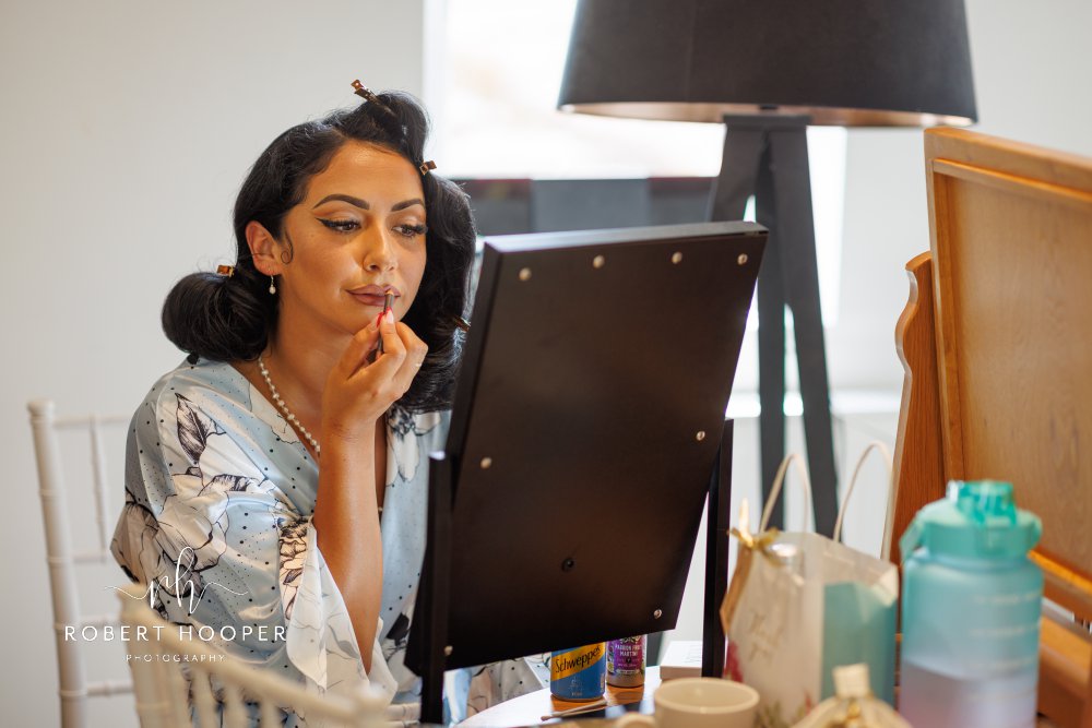 Bridesmaid applying make-up